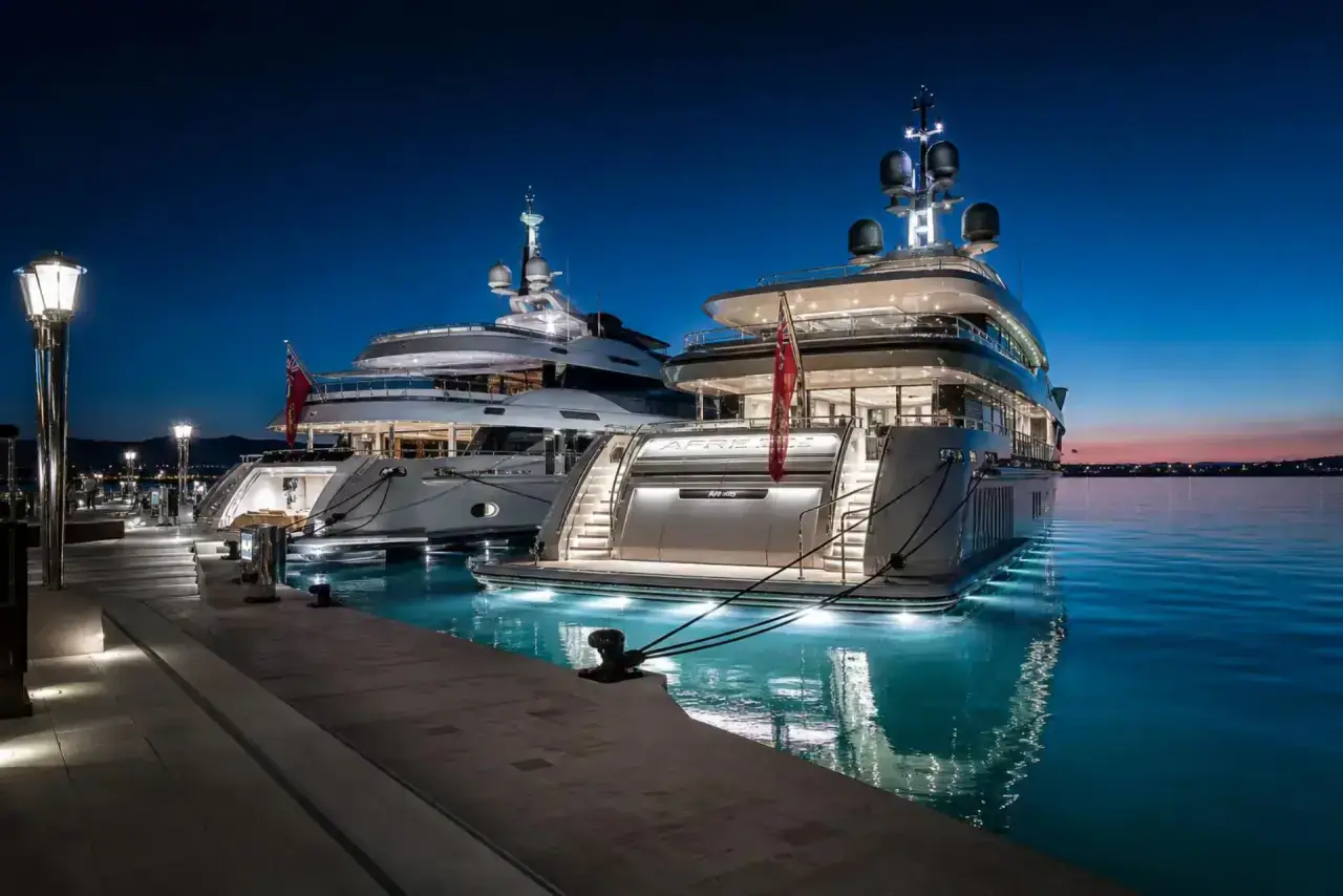 Luxury yachts berthed at a Florida marina at golden hour